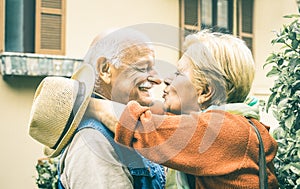 Happy senior retired couple having fun kissing outdoors at travel time