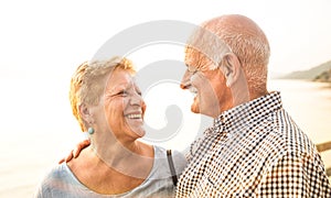 Happy senior retired couple having fun outdoors at travel vacation