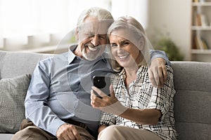 Happy senior retired couple talking on online video call