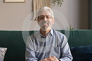 Happy senior retired man looking talking to camera webcam