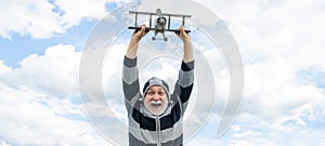 happy senior retired man. mature man at retirement. old man on sky background with toy plane outdoor