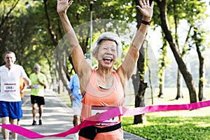 Happy senior running through the finish line photo