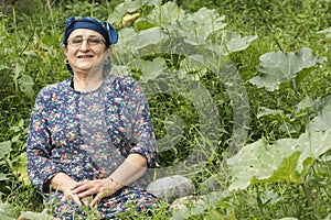 Happy senior 65s farmer woman at pumpkin garden home grown produce