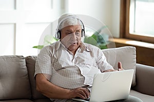 Modern senior man talk on video call on laptop