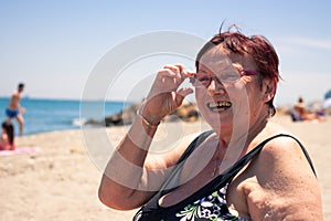 Happy senior woman on the beach