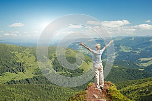 Happy senior woman enjoying the nature in the mountains