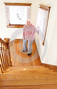 Happy Senior Woman in Front of the Stair