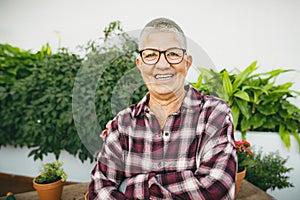 Happy senior woman gardening at home