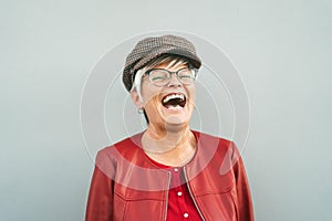 Happy senior woman laughing outdoor - Trendy mature person having fun during retired time