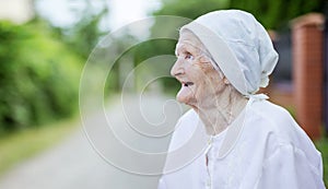 Happy senior woman looking up outdoors