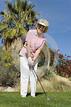 Happy Senior Woman Playing Golf