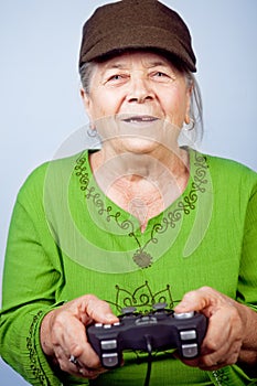 Happy senior woman playing video games