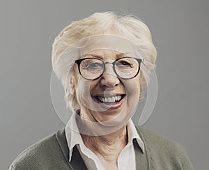 Happy senior woman posing on gray background
