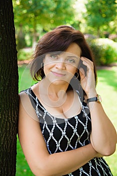 Happy senior woman relaxing and smiling outdoor in a summer day.