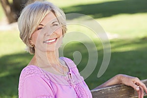 Happy Senior Woman Sitting Outside Smiling