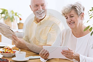 Happy senior woman with tablet