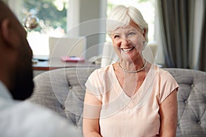 Happy senior woman taking financial advice at home