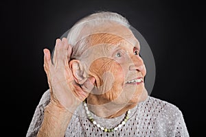 Happy Senior Woman Trying To Hear