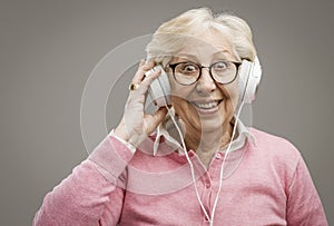 Happy senior woman wearing headphones