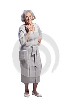 Happy senior woman wearing light dress isolated