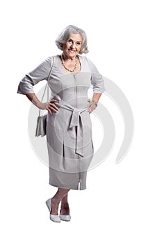 Happy senior woman wearing light dress posing isolated