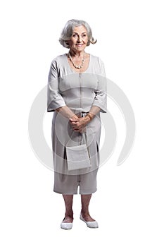 Happy senior woman wearing light dress posing isolated