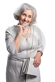 Happy senior woman wearing light dress posing isolated