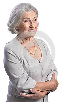 Happy senior woman wearing light dress posing isolated