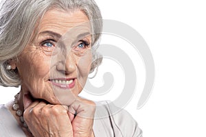 Happy senior woman wearing light dress posing isolated