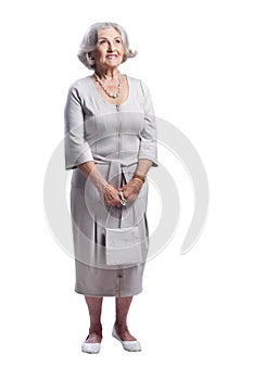 Happy senior woman wearing light dress posing on white background