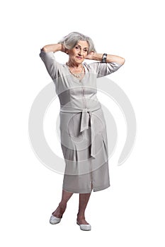 Happy senior woman wearing light dress posing on white background