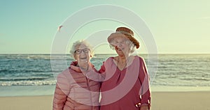 Happy senior women, friends and beach with hug, face and vacation in summer, sunshine and freedom. People, retirement