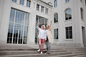 Happy Senior women with gray hair taking selfie photo on mobile phone outdoors at city, laughing and enjoying themselves