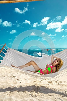Happy sexy and beautiful woman lying in the hammock on the beach with a wonderful white sand - Image