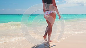 Happy sexy woman in bikini enjoying tropical sea and exotic beach in Punta Cana, Dominican Republic
