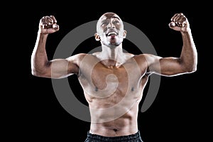 Happy shirtless athlete cheering with clenched fist