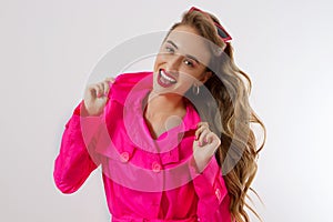 Happy, shock, excited woman face closeup. Girl bright pink autumn clothes, makeup , white background, copy space.