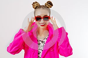 Happy, shock, excited woman face closeup. Girl in bright pink autumn clothes, red sunglasses isolated on white background, copy