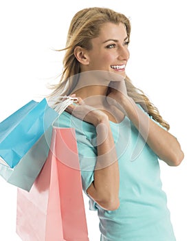 Happy Shopaholic Woman Looking Away While Carrying Shopping Bags photo