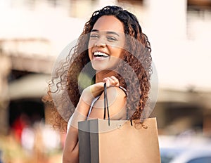 Happy, shopping and black woman with bag from sale, promotion or summer discount on clothing, fashion or retail. Girl