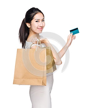 Happy shopping woman with paper bag and credit card