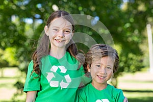 Happy siblings in green smiling at the camera