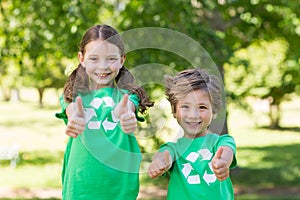 Happy siblings in green with thumbs up