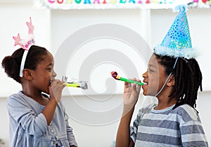 Happy siblings having fun at a birthday party