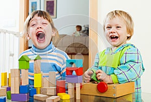 Happy siblings together playing with blocks