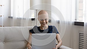 Happy sick young woman relax at home with laptop