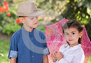 Happy sister and brother posing in the garden