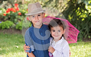 Happy sister and brother posing in the garden