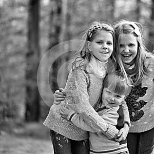 Happy sisters. happy children friends in forest