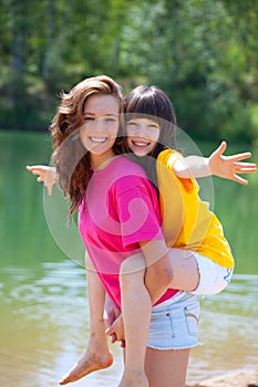 Happy sisters by lake